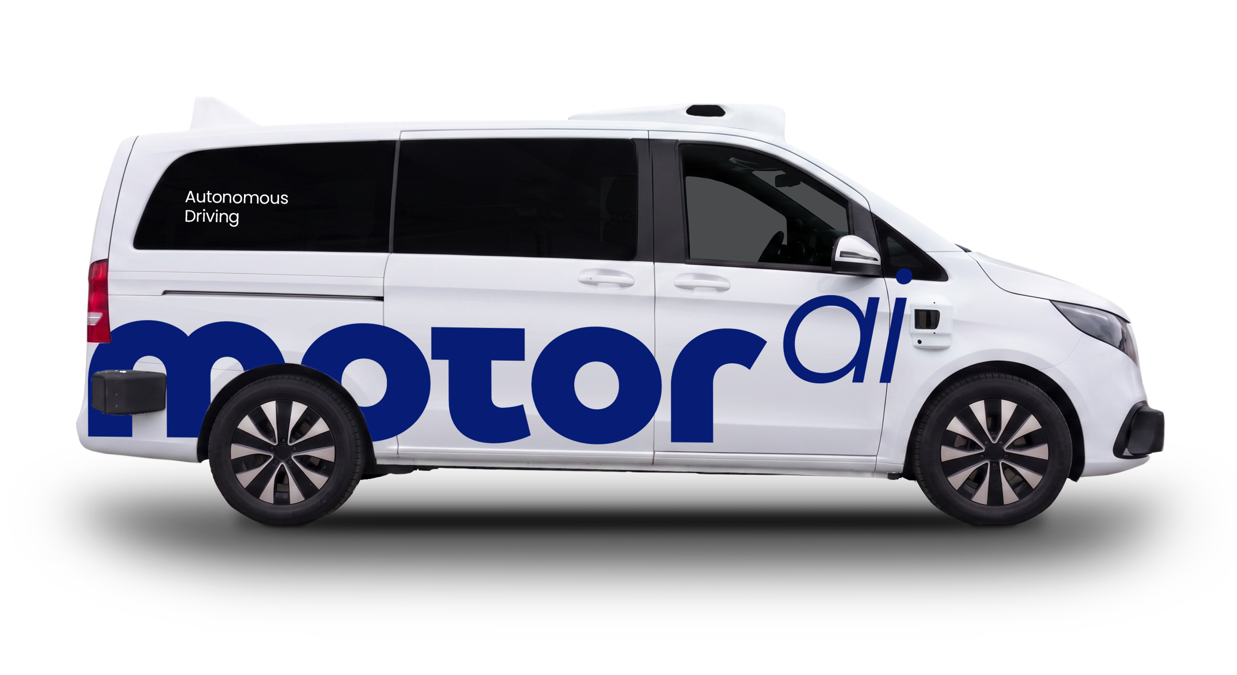 White autonomous vehicle with large blue lettering on side and small black text that reads “MOTOR Ai"