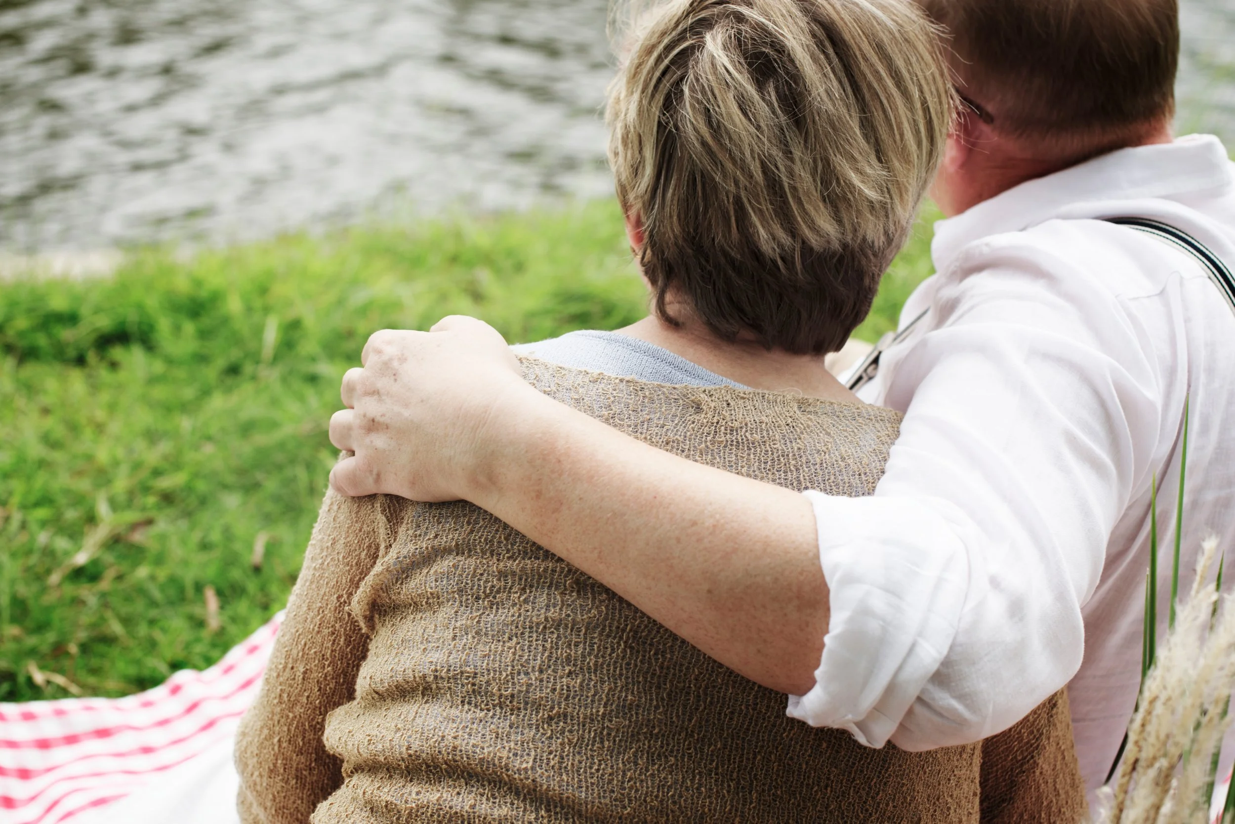 Husband with arm warmly around his wife
