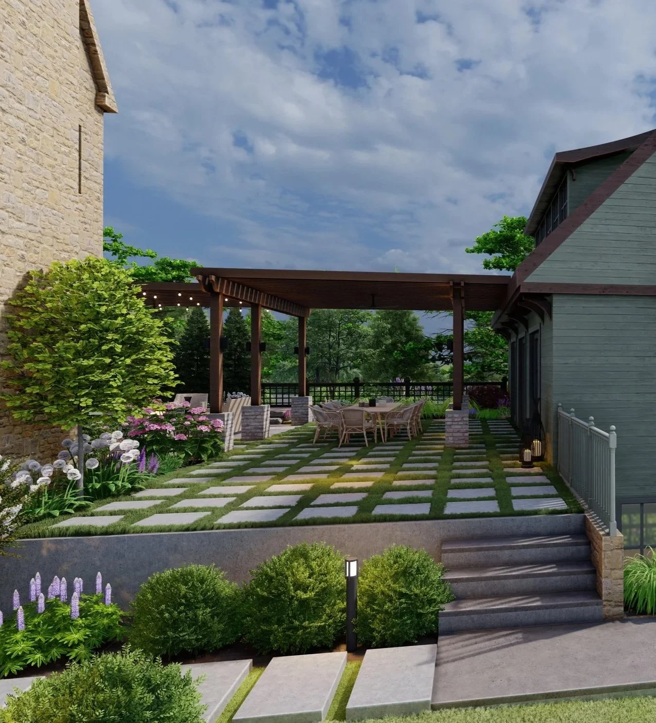A landscaped backyard patio with stone pavers, a wooden pergola covering a dining table with chairs, surrounded by lush green plants and flowers, adjacent to stone and wooden houses under a partly cloudy sky.