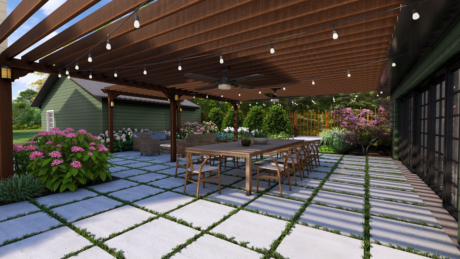 A backyard patio with a wooden pergola, outdoor furniture, potted plants, pink and white flowers, greenery, and string lights.