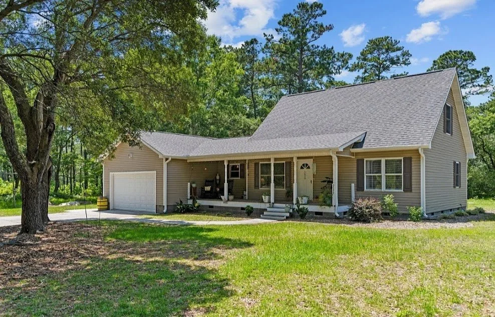 Beige residential rental home with front porch and garage managed by Allied Property Management in The Triangle, NC.