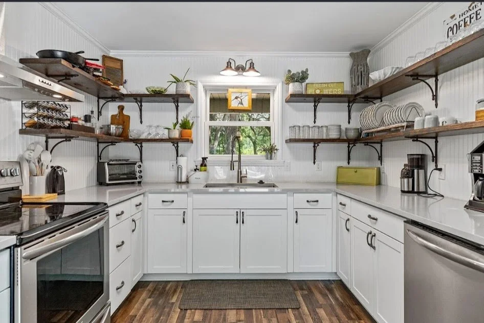 Remodeled rental kitchen with open shelves and white cabinets. Rental property renovation services in Southport, NC.