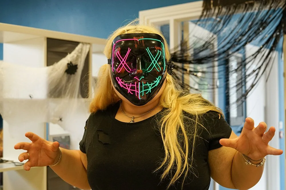 A photo of a young carer in a haloween mask