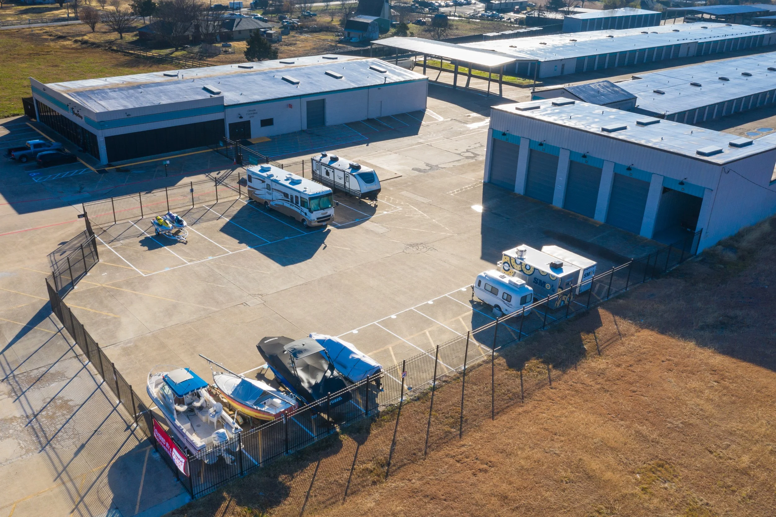Aerial view of the Wylie Bargain Storage property showing enclosed units, covered and uncovered RV, boat, and trailer parking
