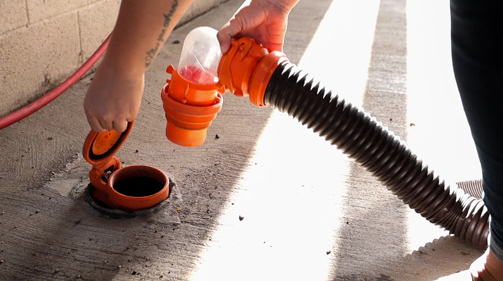 Customer connecting a sewer hose at the RV dump station in Chandler, AZ