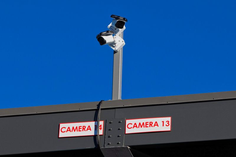 Close-up of two HD security cameras labeled Camera 13 and Camera 14 monitoring the Wylie, TX storage facility