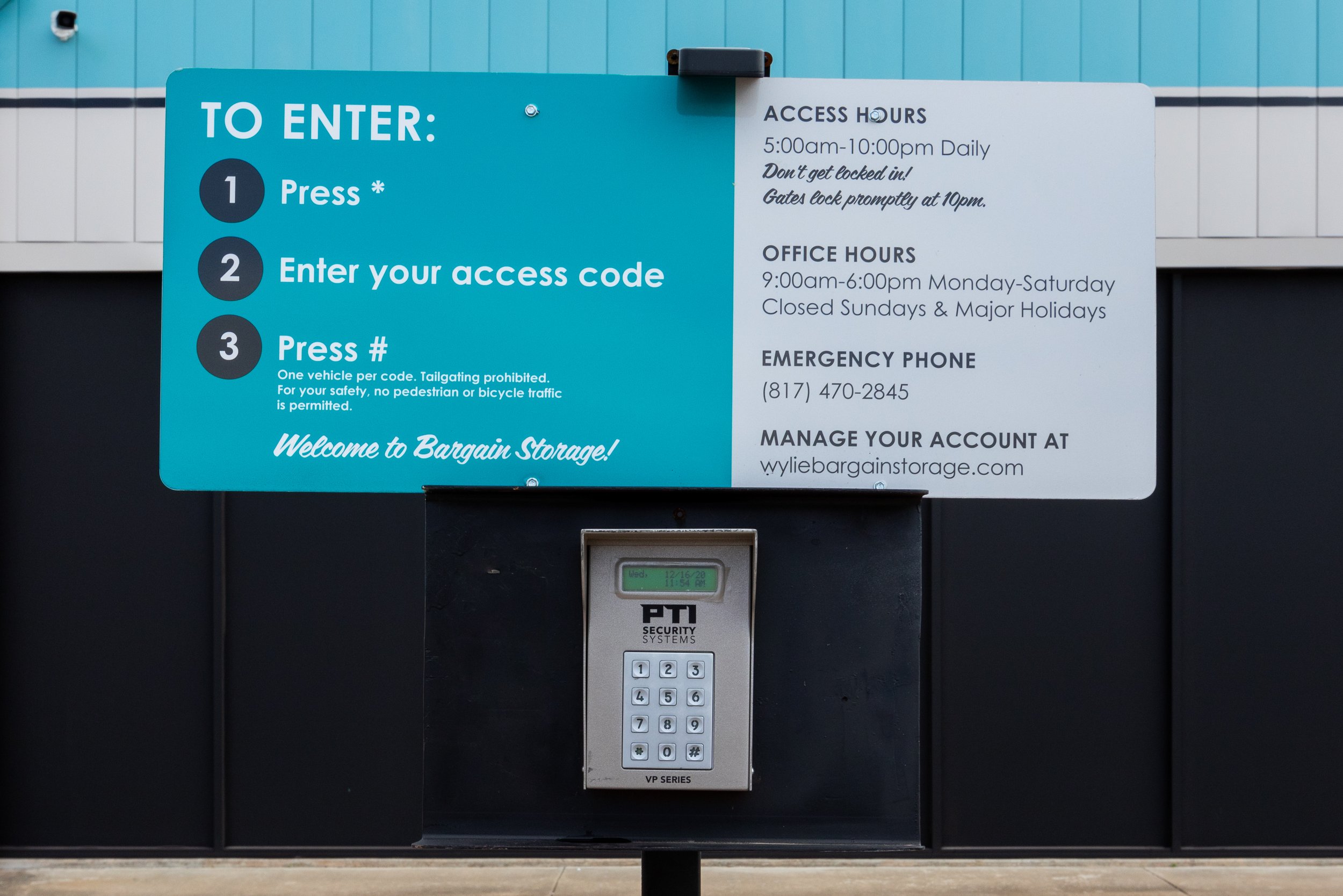 Keypad gate access panel with entry instructions, access hours, and emergency contact at Wylie Bargain Storage