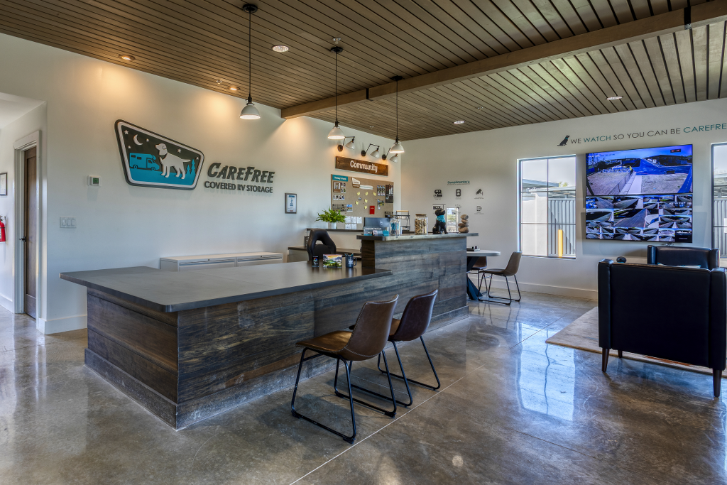 Bright, modern lobby of the Carefree Welcome Center in Wylie, TX, with a live security-camera monitor wall — available to Osage Lane customers 0.8 mi away