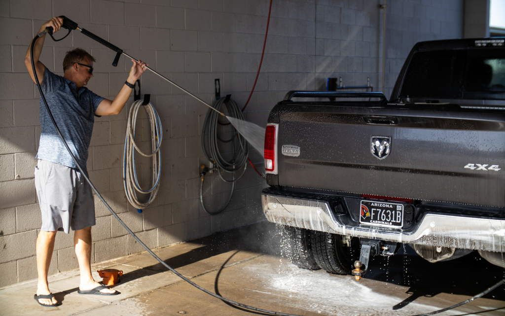 Customer washing his truck at the free vehicle wash bay, Carefree Covered RV Storage in Apache Junction, AZ