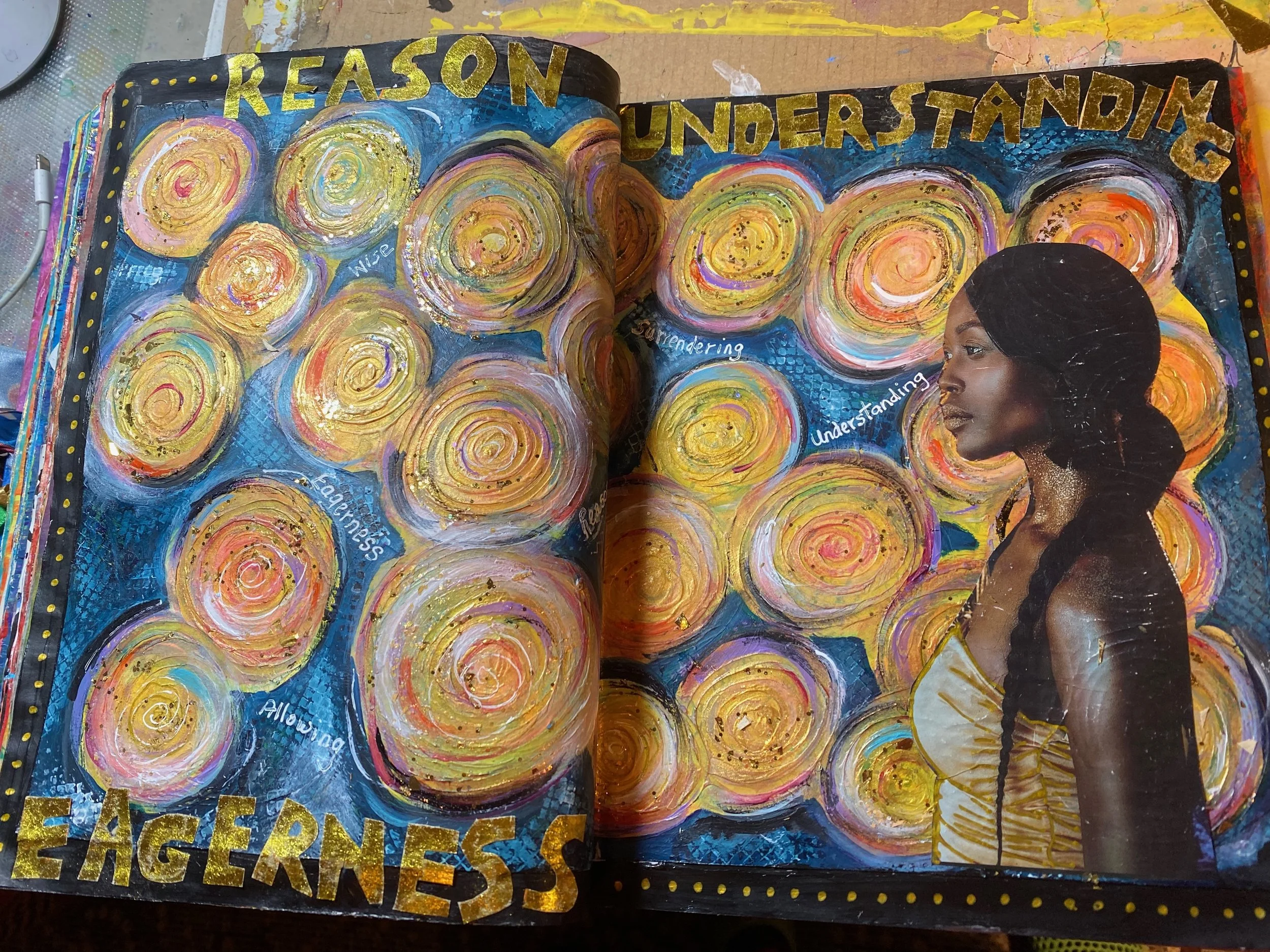 A colorful mixed media artwork featuring a painted portrait of a woman with dark hair and a galvanized metal background decorated with swirling patterns and motivational words such as "reason," "understanding," "allowing," and "eagerness."