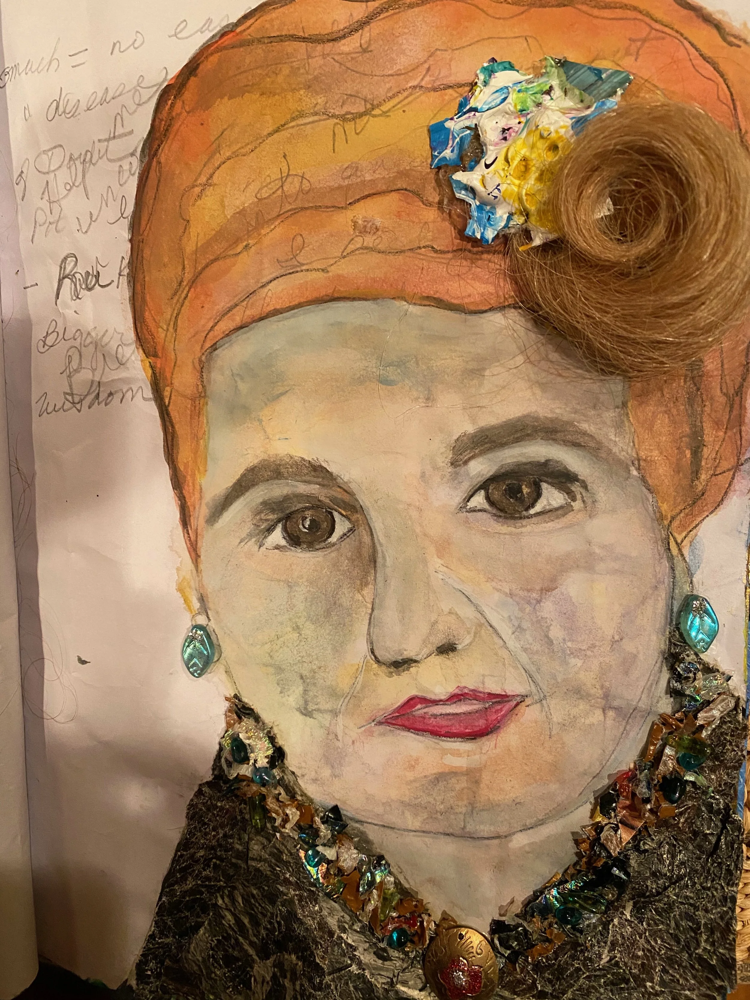 Hand-drawn portrait of a woman with brown eyes, red hair, and jewelry, embellished with various colorful materials, including crumpled paper and shiny objects, around her head and neck.
