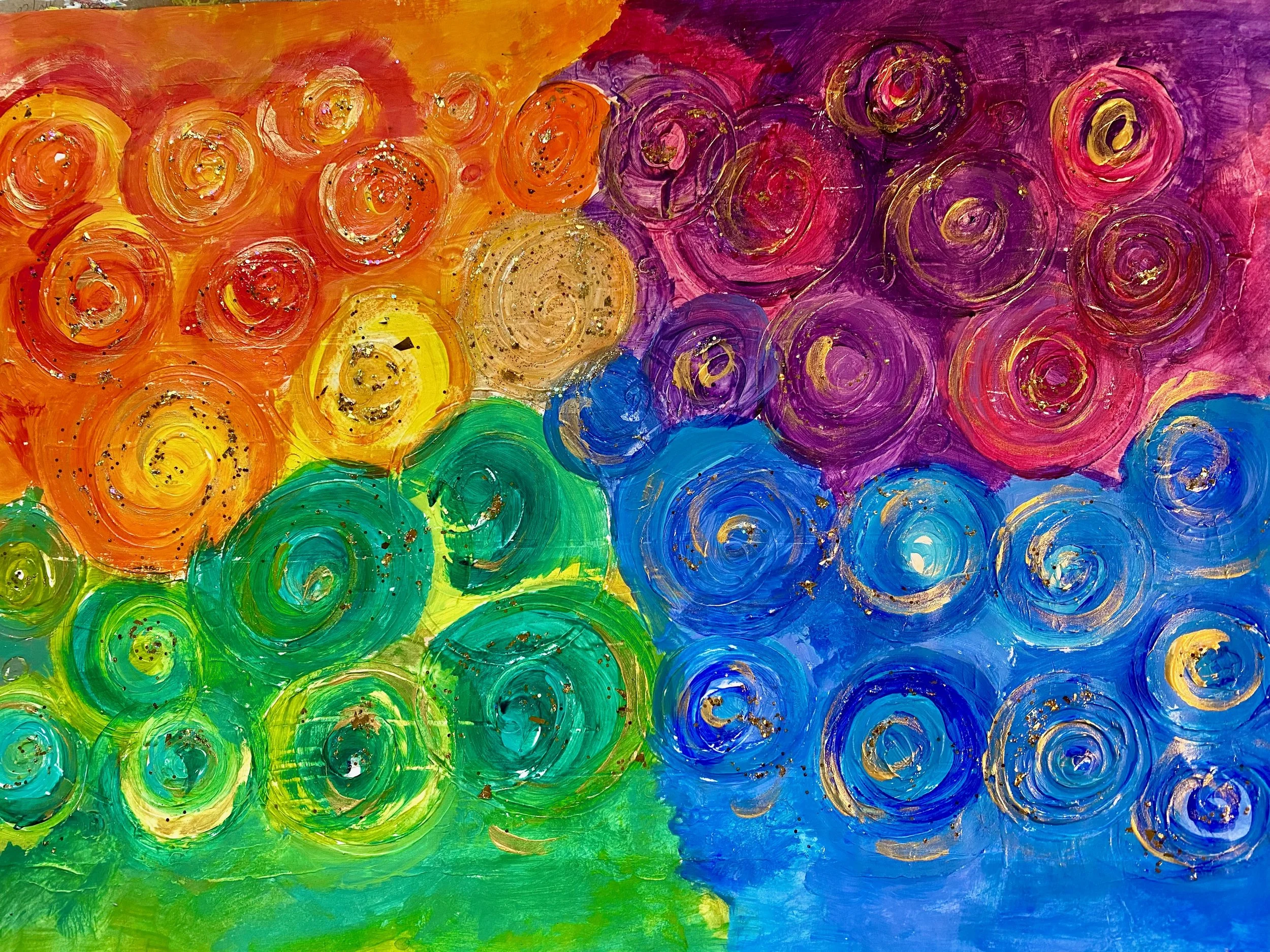 An abstract painting created with swirling brushstrokes of colors including yellow, orange, red, purple, blue, and green. Gold and black speckles are scattered across the swirls.