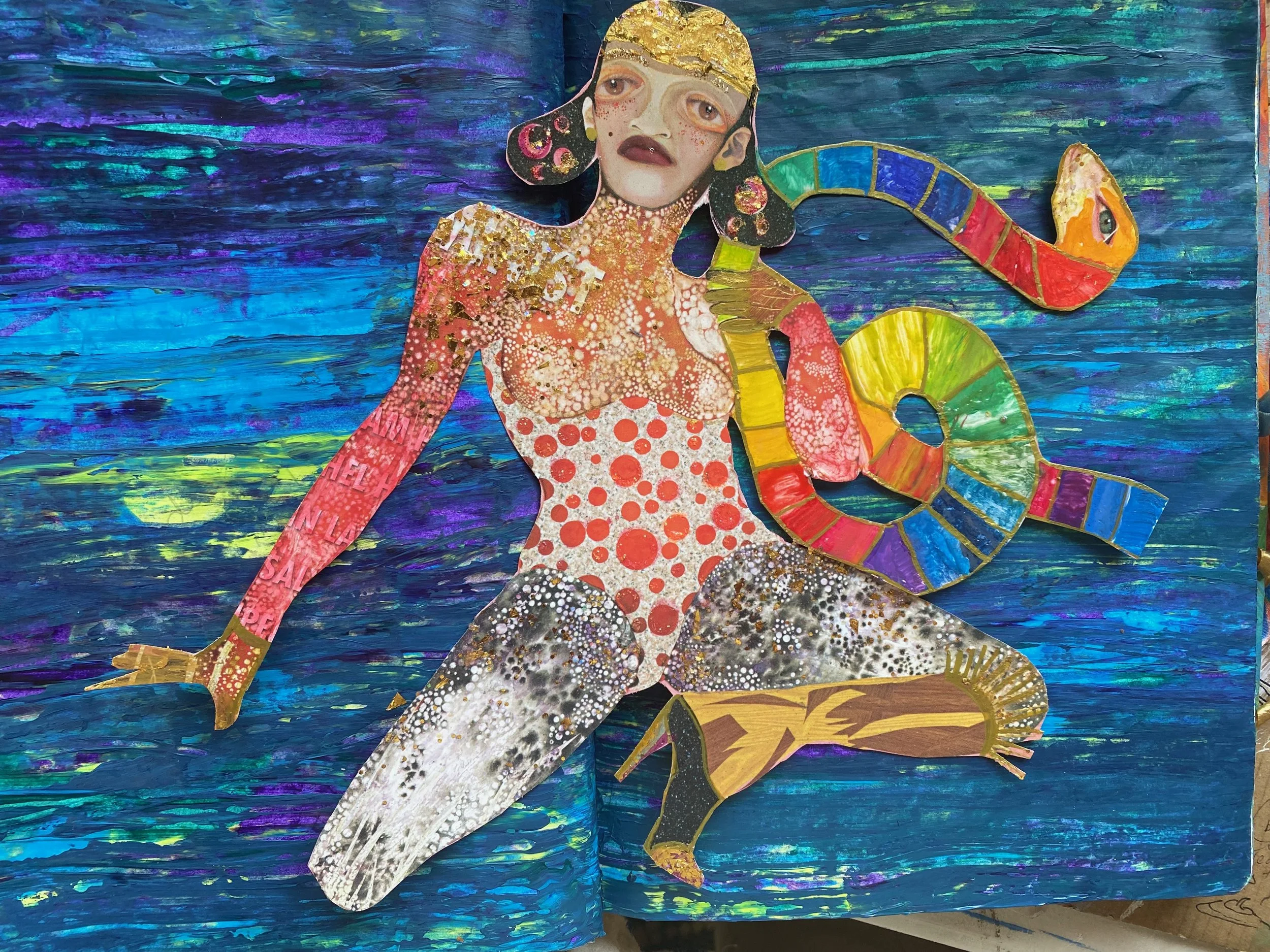 A mixed media artwork featuring a portrait of a woman with makeup and freckled face, with hair resembling a cassette tape. The background is a vibrant, textured blue with purple and green hues. There is a stylized multicolored snake coiled around her