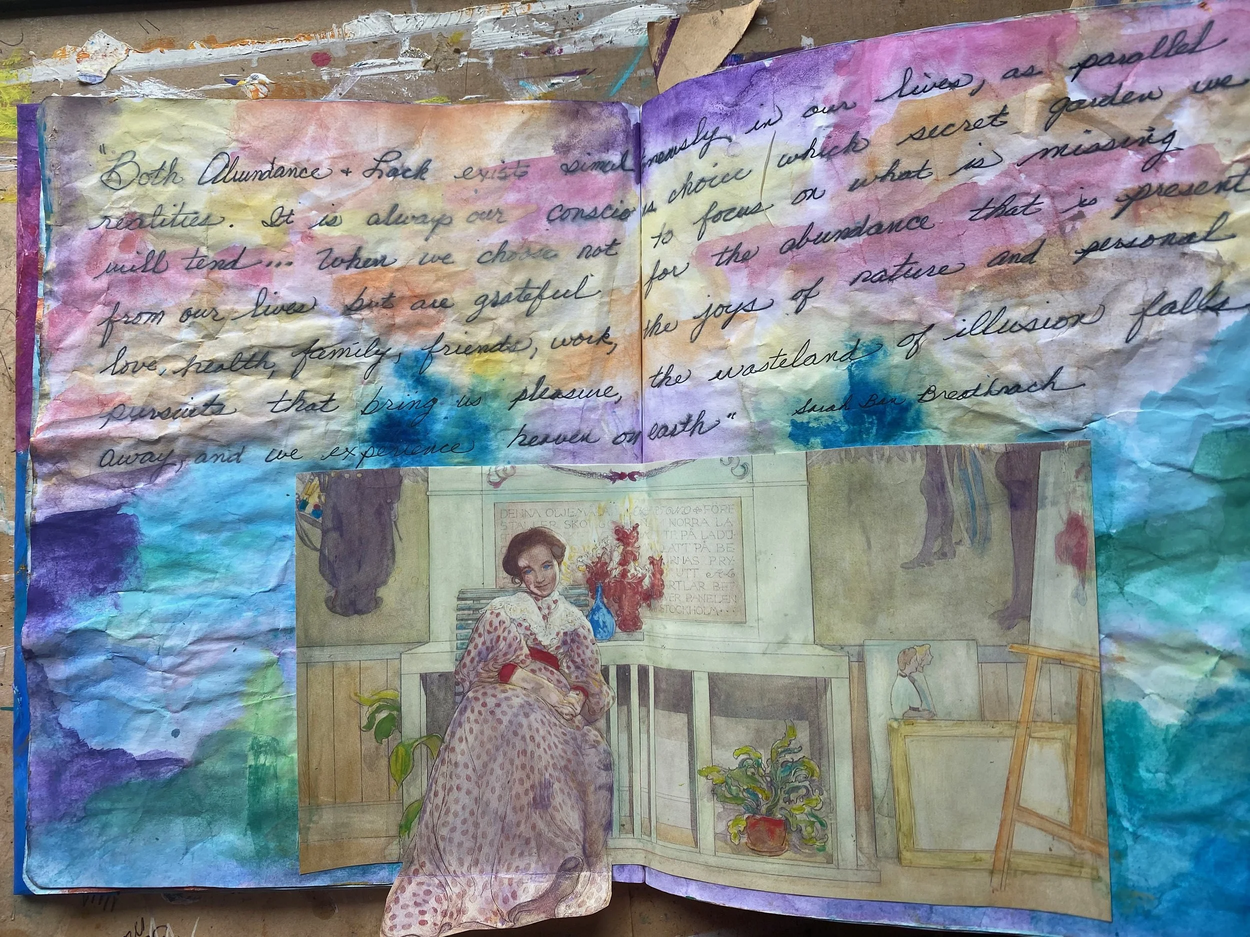 An open watercolor-painted journal with handwritten text and a vintage illustration of a woman sitting on a bench, surrounded by colorful abstract backgrounds and small sketches.