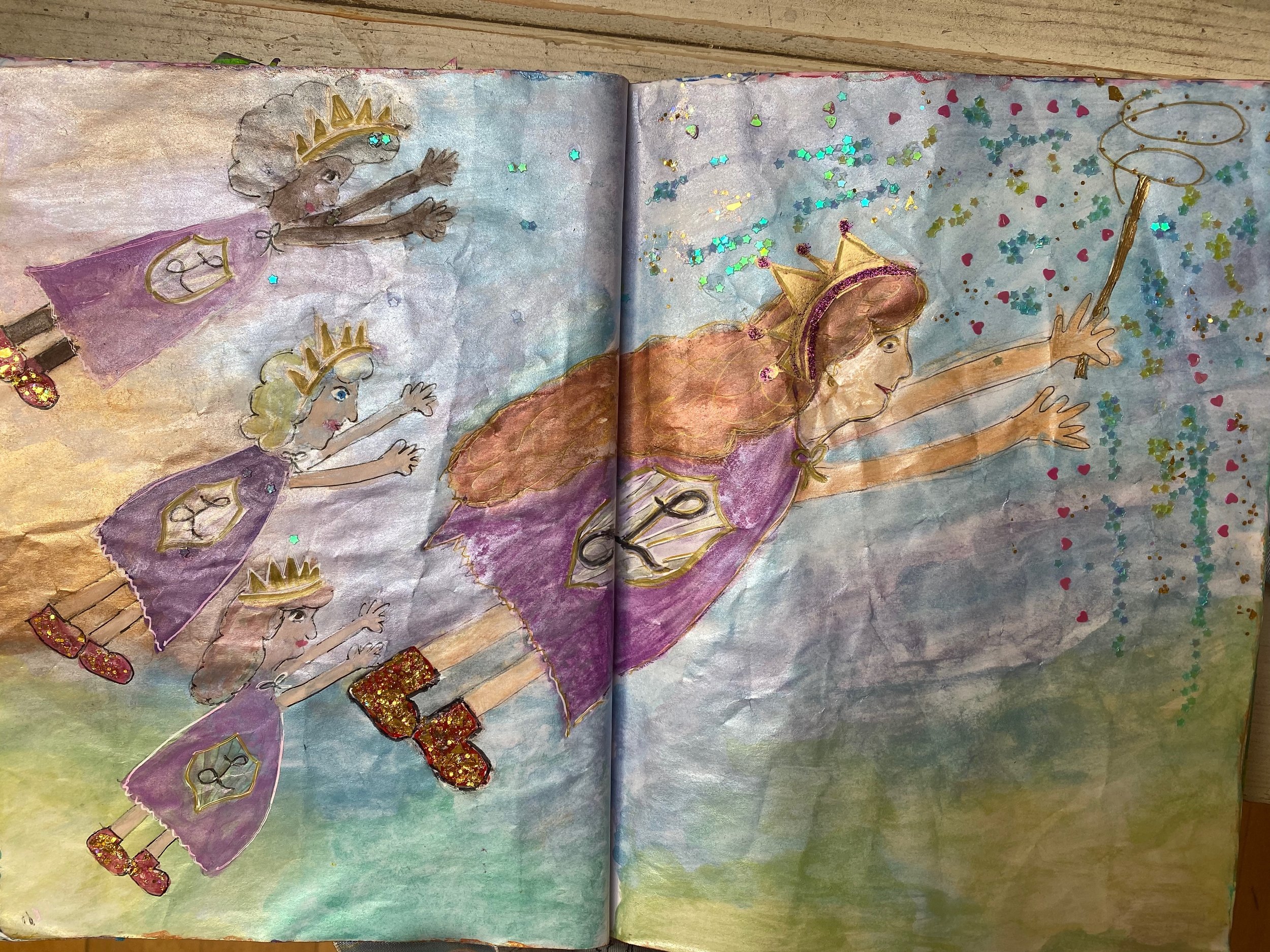 A colorful illustration of a queen surrounded by four princesses, all reaching forward. The queen is wearing a crown and a pink dress, while the princesses are in purple dresses with crowns. There is glitter and confetti in the background.