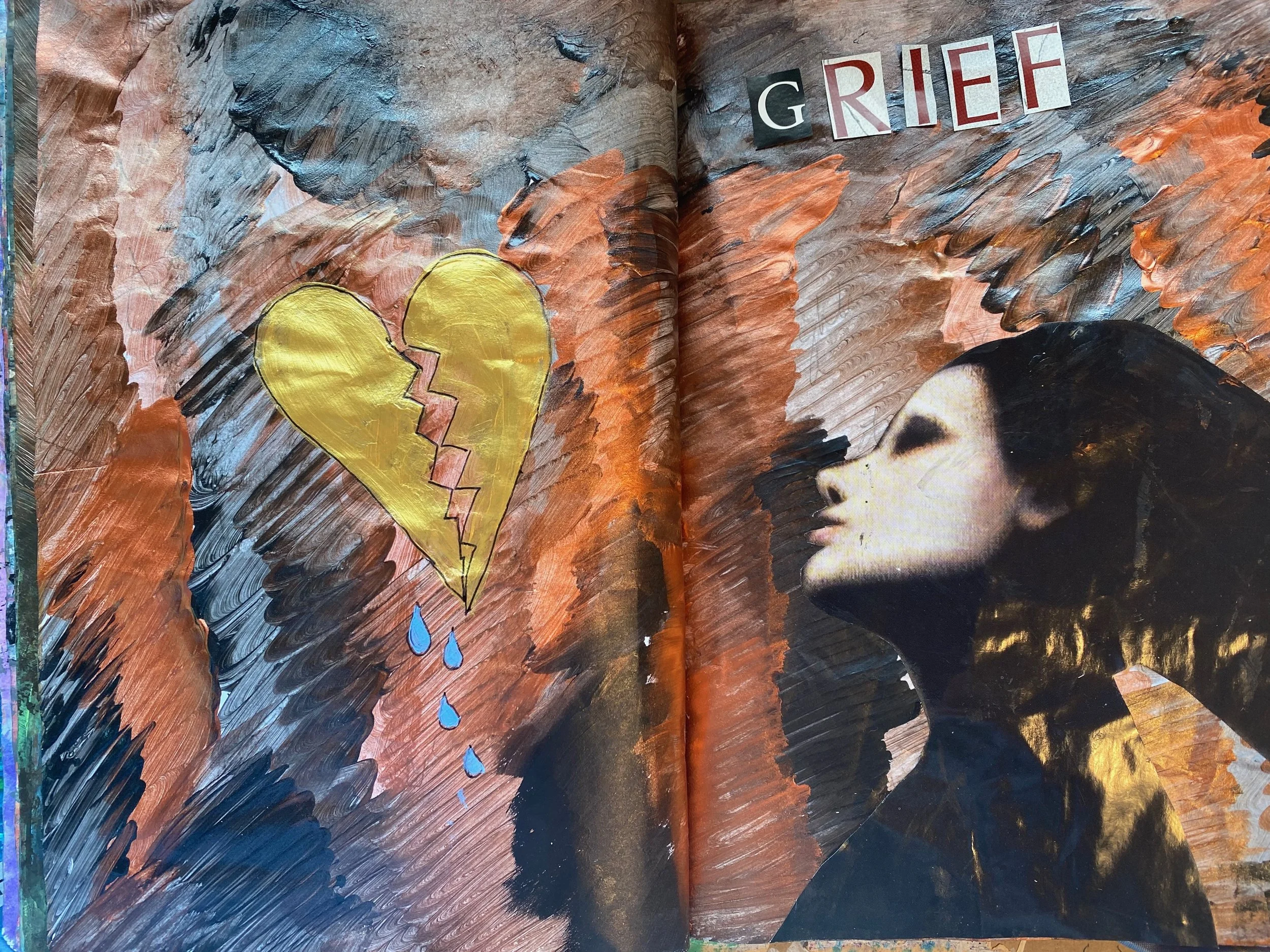 An open sketchbook page with colorful, textured painting. The painting features a broken yellow heart with blue tears falling and the word "GRIEF" spelled out in separate letters on a dark, swirling background.