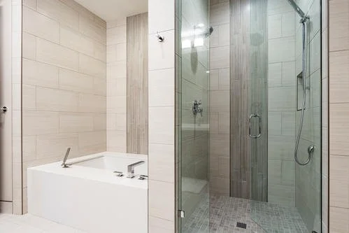 Modern bathroom with bathtub and glass-enclosed shower area