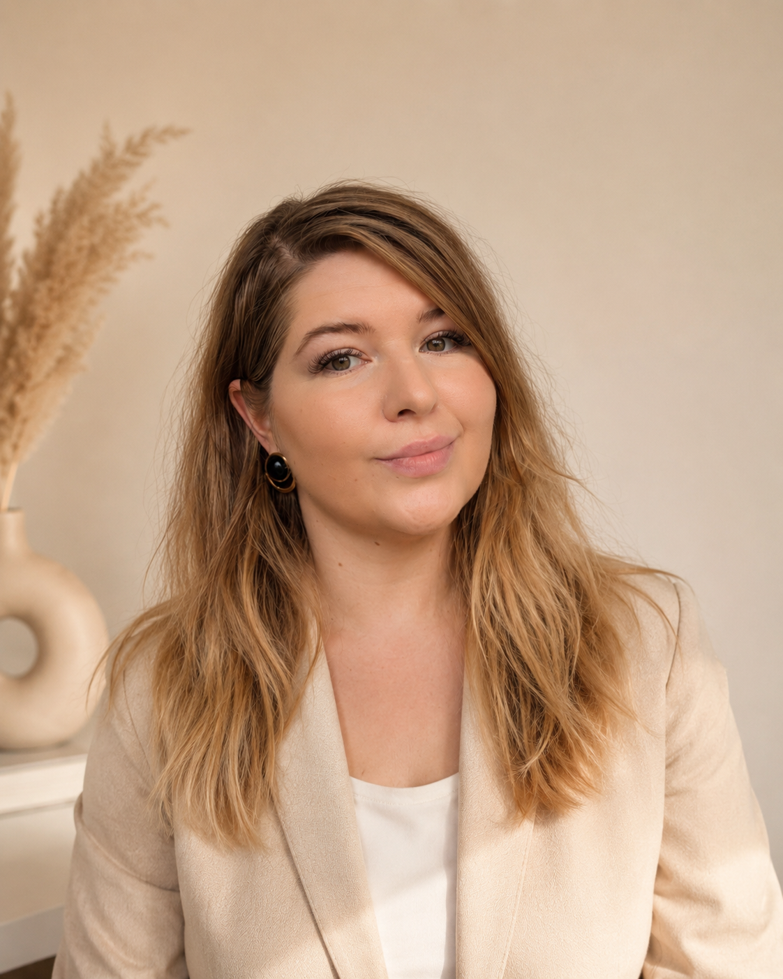 Portrait of Elizabeth Demine in a warm, minimalist setting.