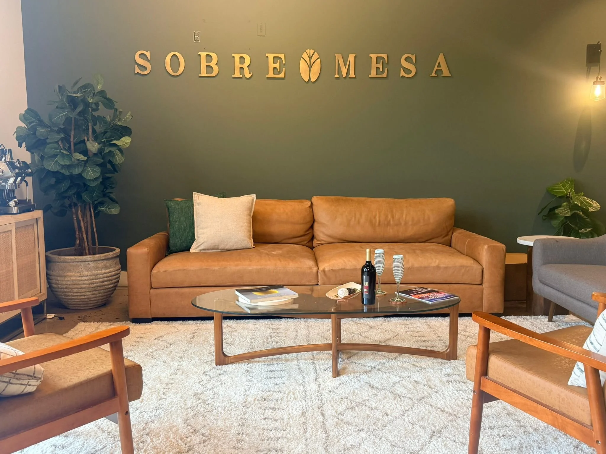 Sobre Mesa cooking studio lounge with seating and the Sobre Mesa sign in Huntsville.