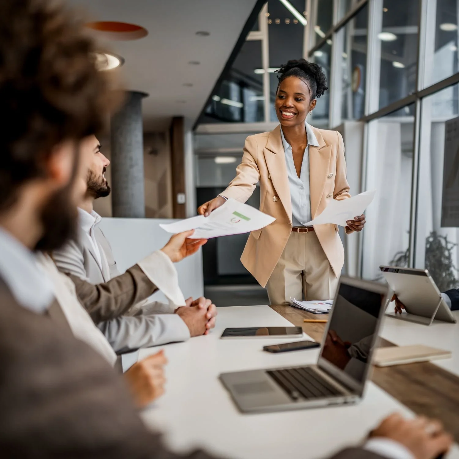 Woman handing out business reports at meeting, specialized ERP and IT staffing