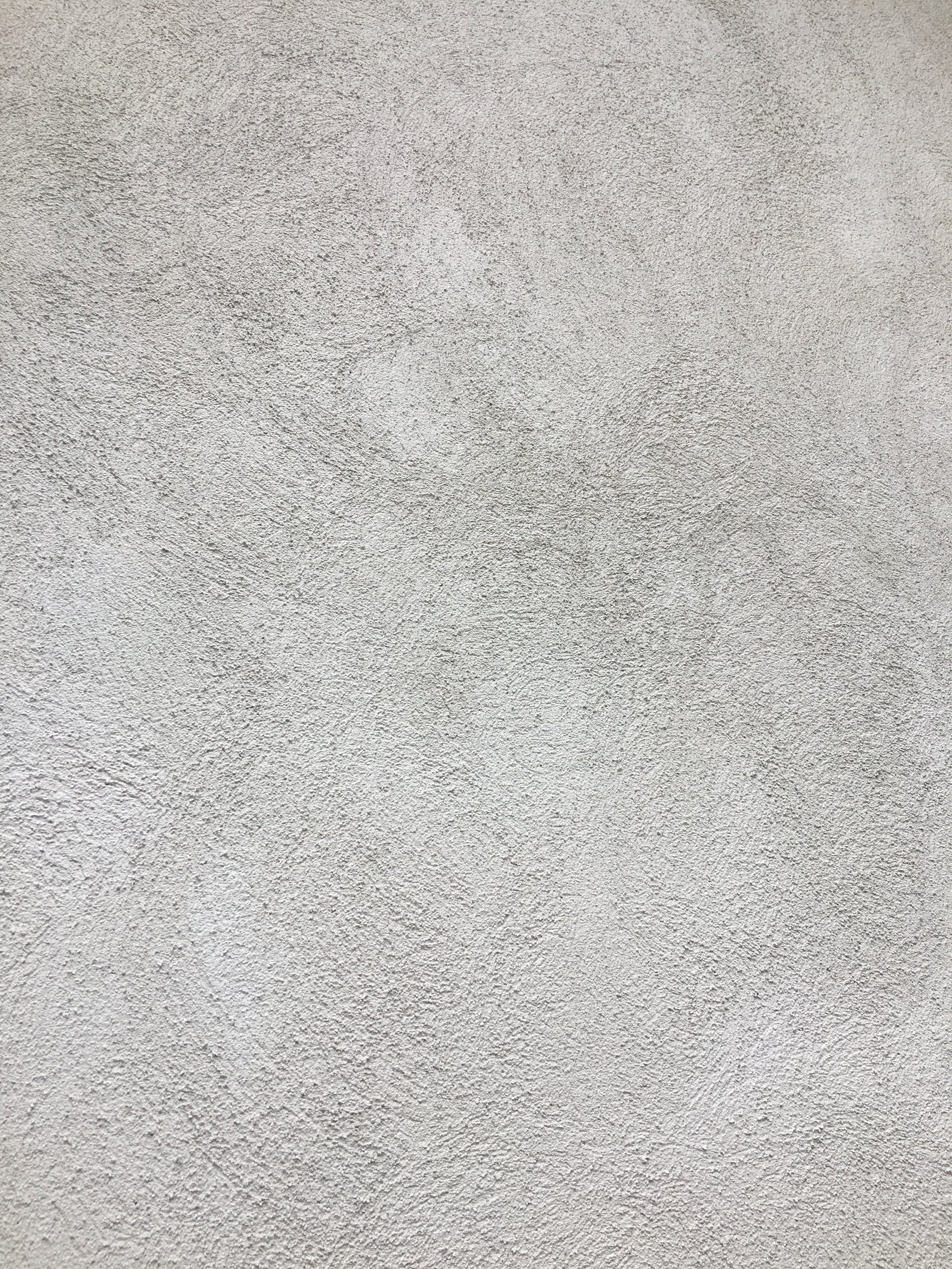 A close-up photo of a textured, off-white wall surface.