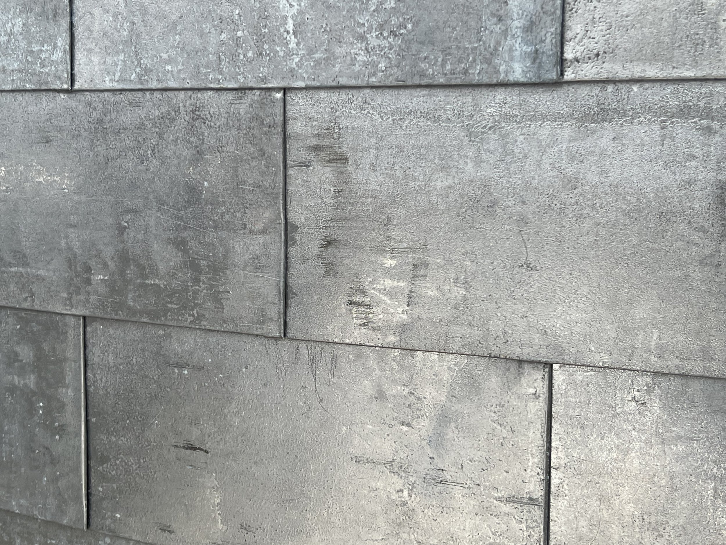 Close-up of grey concrete tiles stacked together.