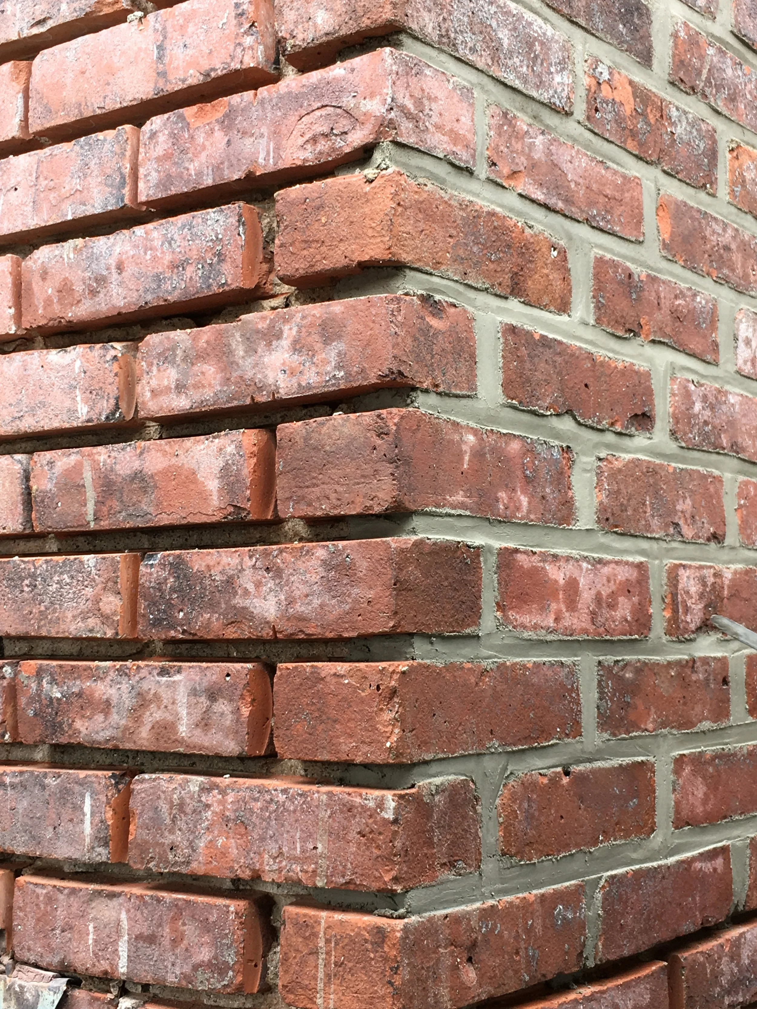 Close-up of a red brick wall with mortar joints.