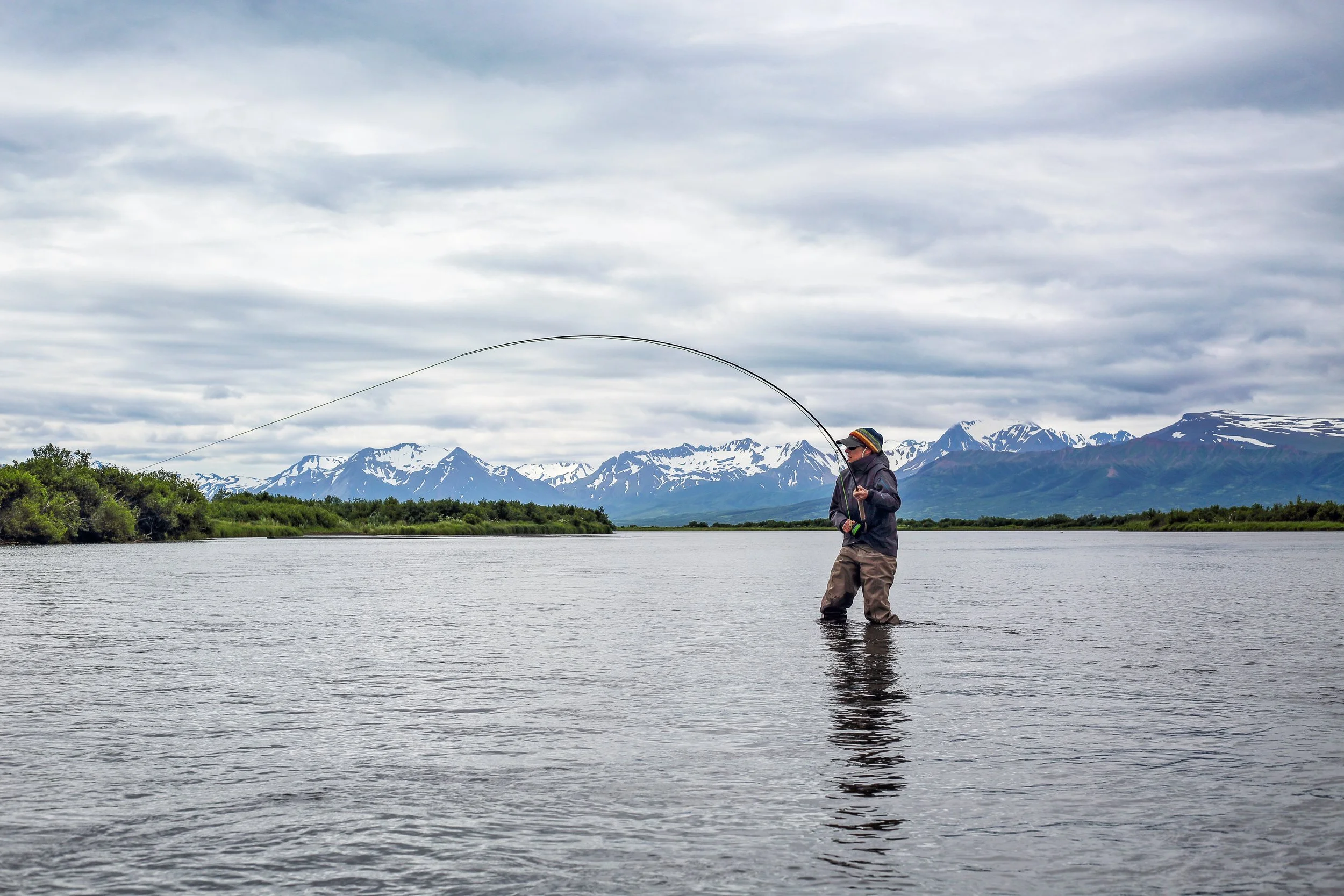 Angler fishing in a river at Lava Creek Lodge, Alaska Peninsula.