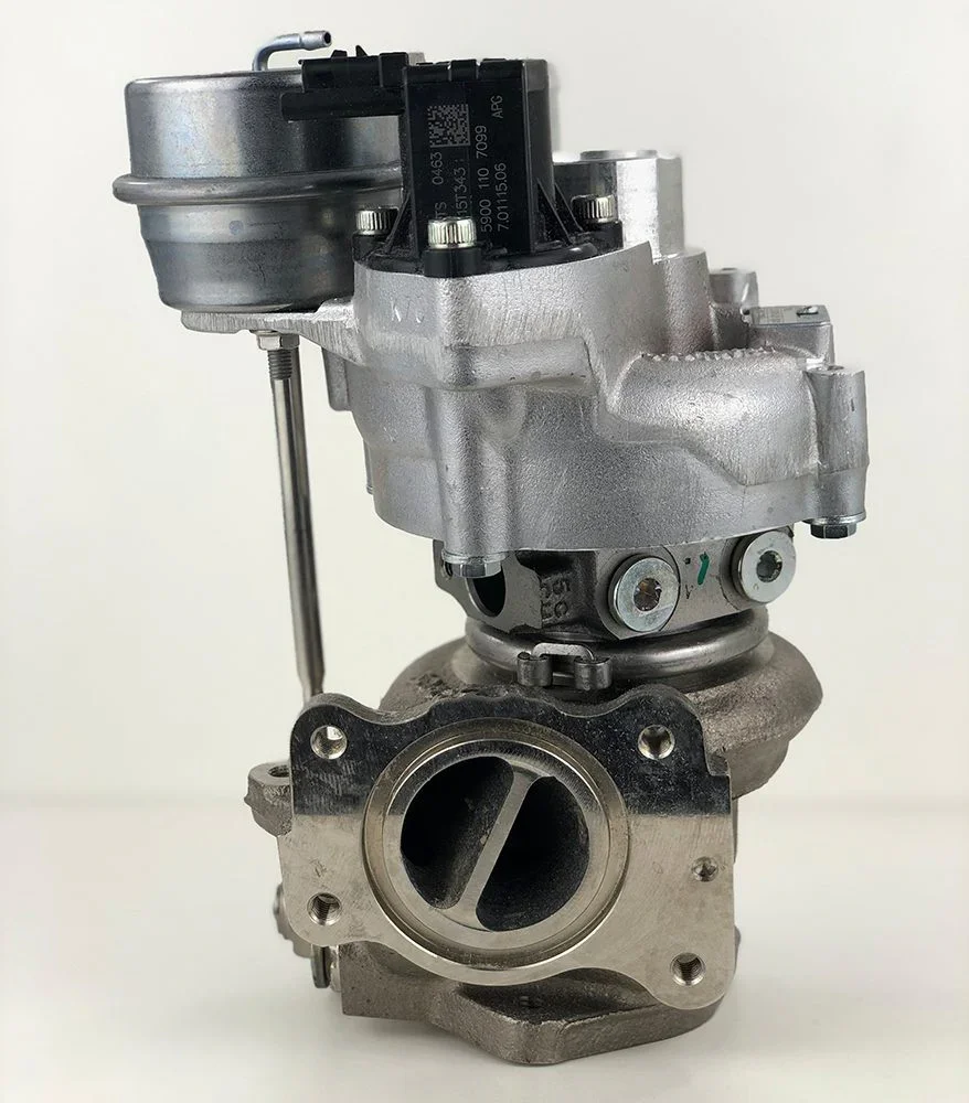 A turbocharger assembly, showing the turbine housing with an opening for airflow and the compressor housing attached on top, with components for mounting and connection.