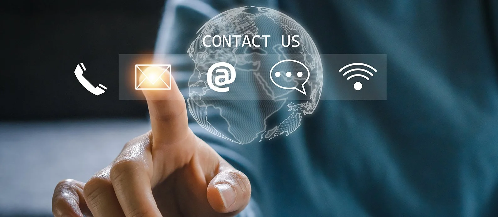 A person touching a virtual contact icons overlay, including phone, email, at symbol, chat, and Wi-Fi, with a digital world map background.