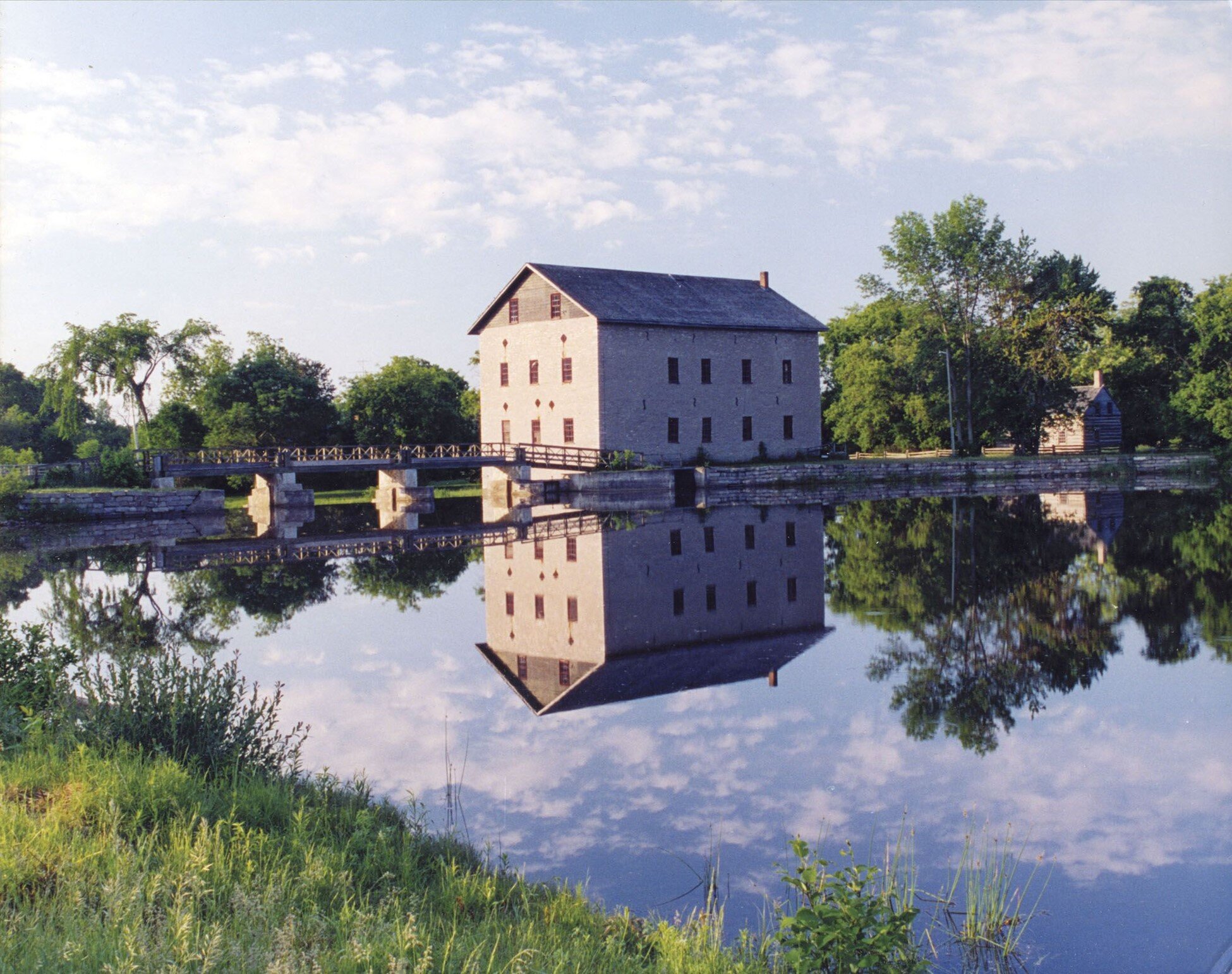 Lang Grist Mill and bridge over waterfall dam at Pioneer Village near Keene, Ontario.&nbsp;