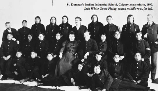 St. Dunstan’s Indian Industrial School, Calgary, 1897. Jack White Goose Flying seated middle-row, far left. Photo from White Goose Flying Report.