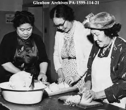 Mrs. C.H. Poon, Mrs. C.Y. Mah, and Mrs. L. Ying preparing food for Chinese United Church event, Calgary, Alberta. 1958. Digital Identifier: PA-1599-114-21. Courtesy the Glenbow Digital Collection.