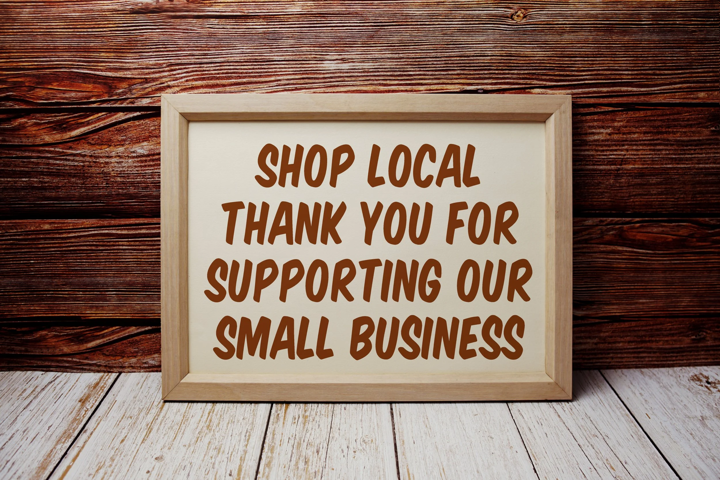 Shop local sign thanking customers for supporting small businesses in downtown Acworth