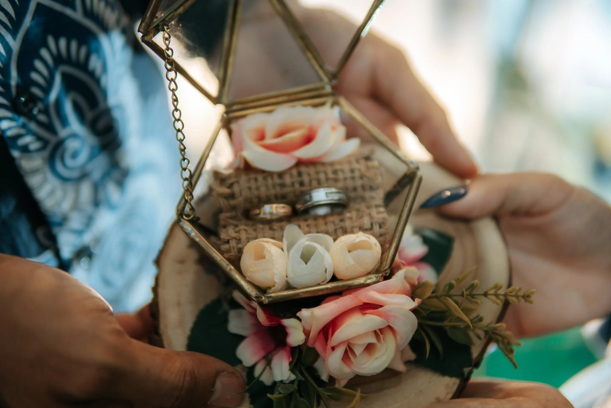 Heirloom rings displayed in a decorative glass keepsake box with flowers for Grandparents Day