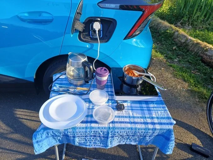 Cooking dinner using the VtL, Brodick, Isle of Arran, 2026. The bike is waiting patiently to the side for its turn on the VtL.