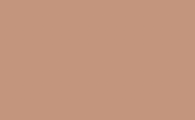 A solid light coral pink background with no objects or details.