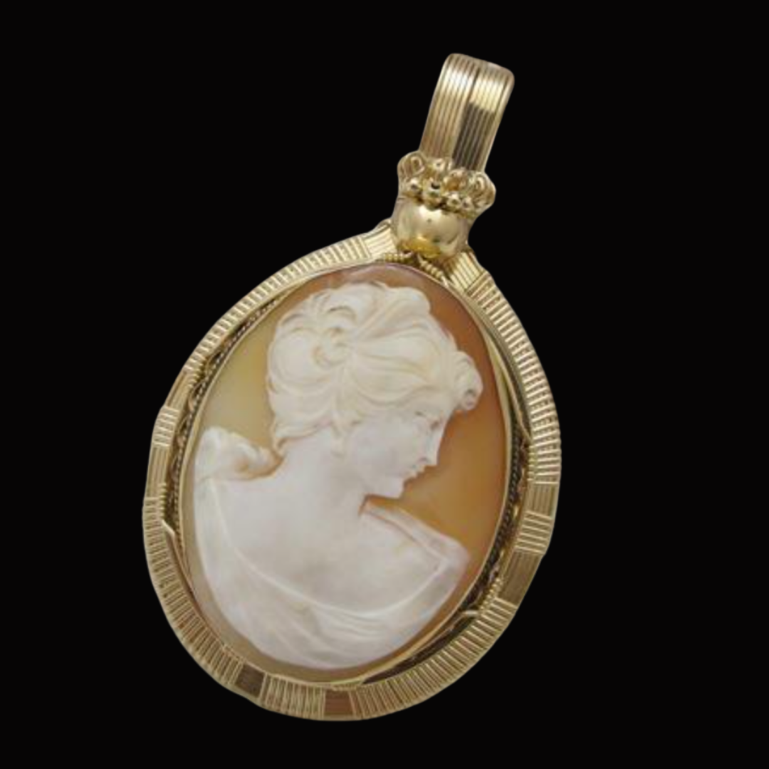 Gold pendant with an engraved white cameo of a woman's profile on a black background.