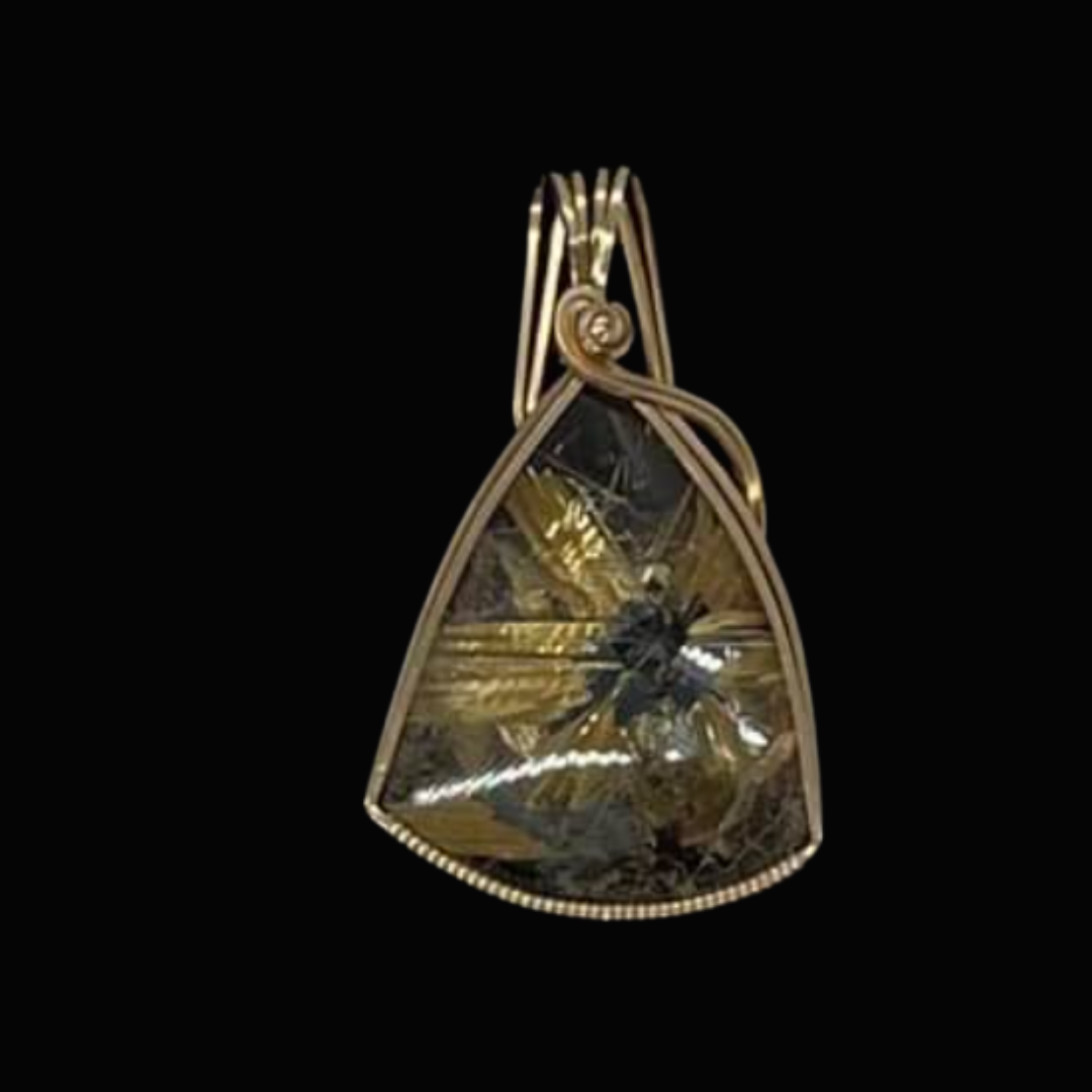 Gold pendant with a teardrop-shaped face, adorned with a black gemstone, on a black background.