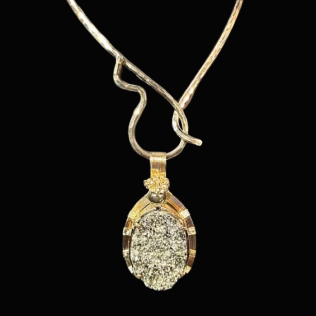 Gold and silver necklace with a large oval diamond pendant against a black background.