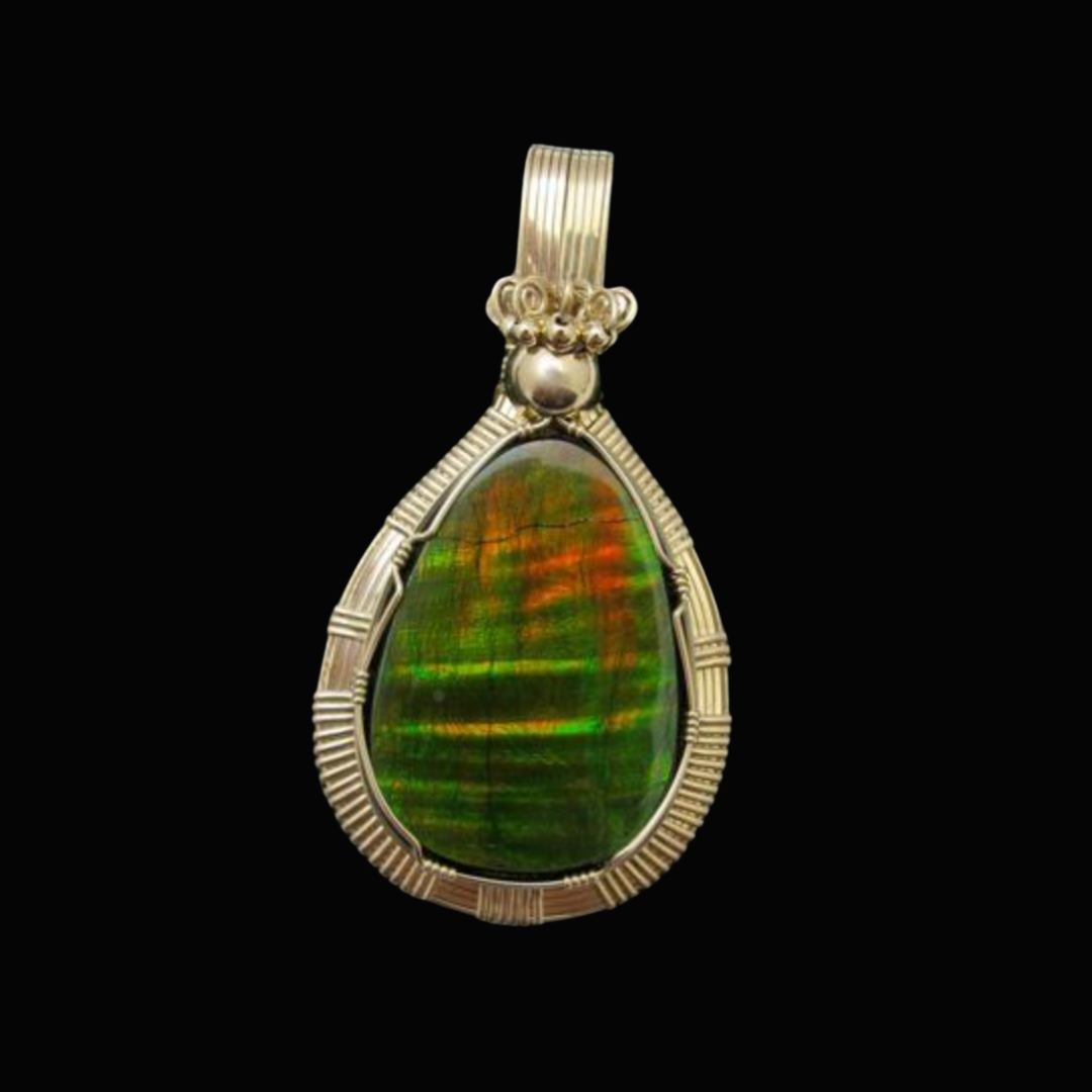 Pendant featuring a large, iridescent green and orange gemstone wrapped in silver wire with ornate silver settings on top.