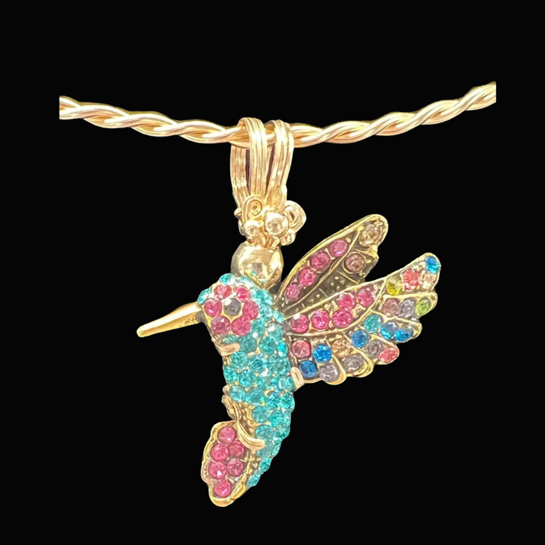 Gold necklace with a hummingbird pendant decorated with multicolored gemstones