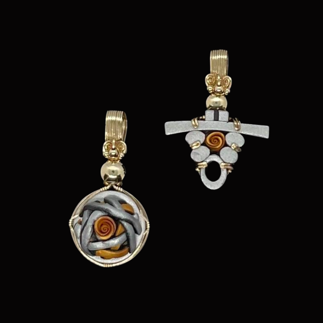 Two artistic earrings with metal and spiral design elements displayed against a black background.