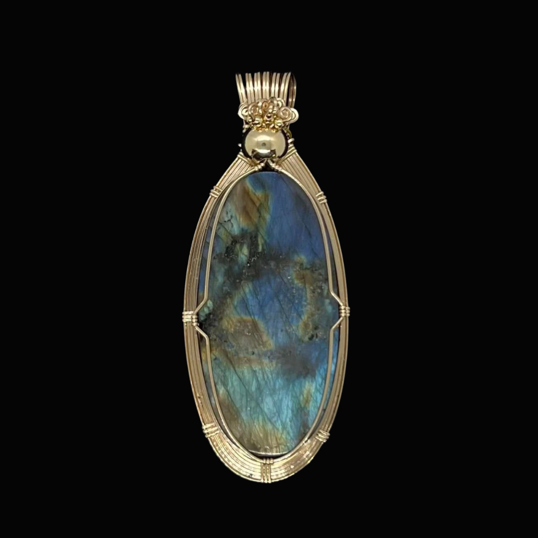 Elegant pendant with a large oval-shaped labradorite gemstone set in a gold wire wrap setting.