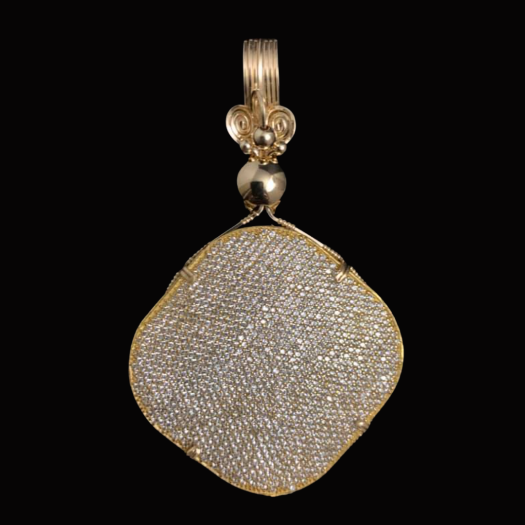 Gold pendant with a large, rounded, and flat shape, covered in numerous small, sparkling diamonds, against a black background.