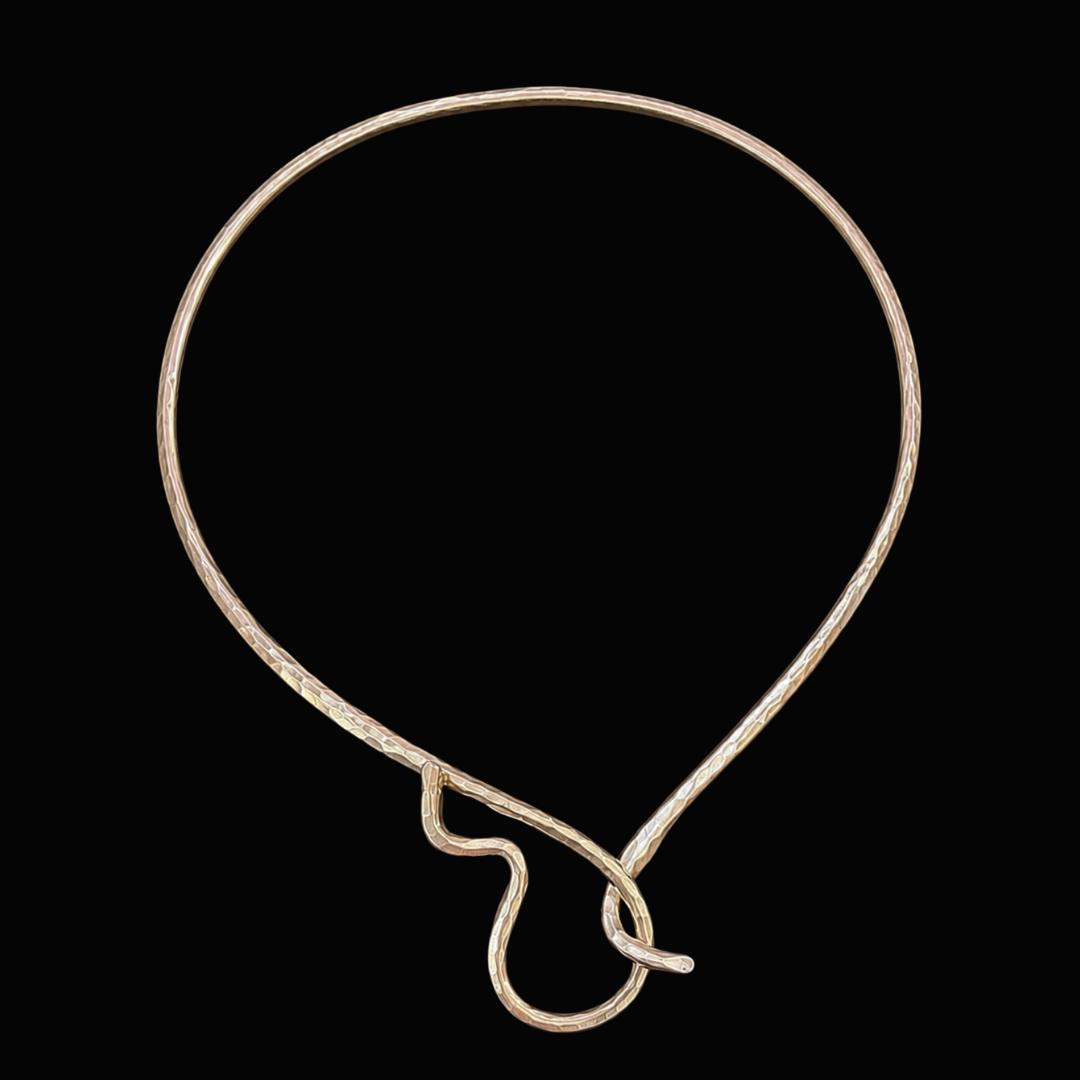 A gold neck wire necklace on a black background.
