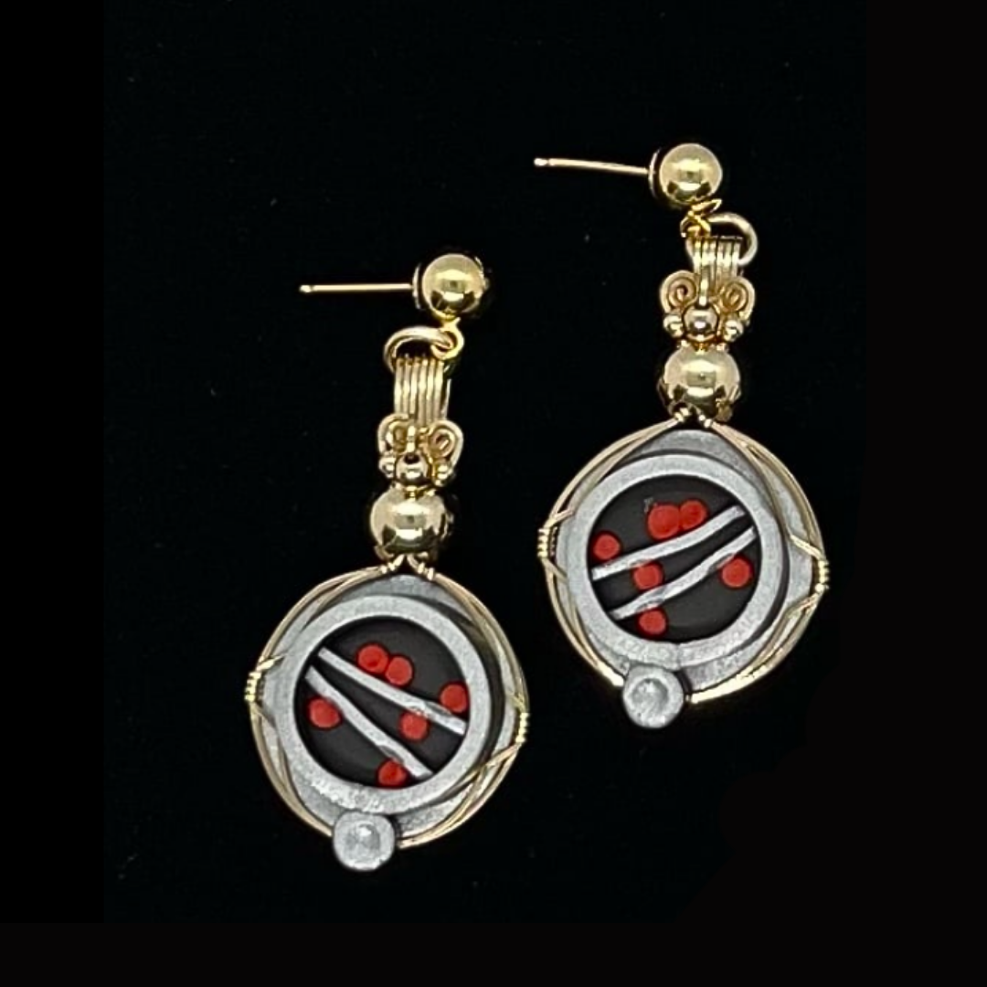 Gold and silver earrings with red, black, and white design resembling a roulette wheel.