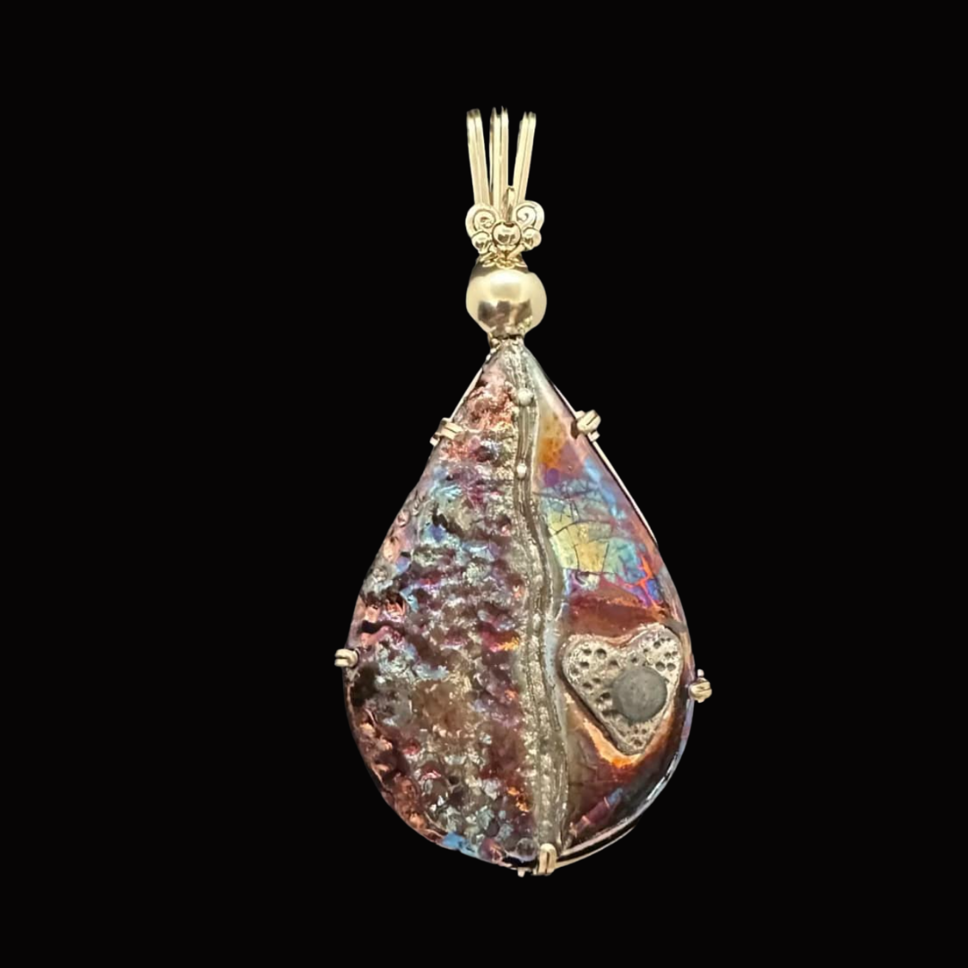 Colorful teardrop-shaped pendant with a heart design, set against a black background.