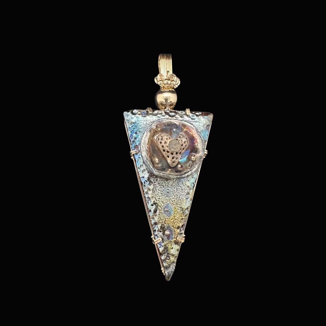 Silver triangular pendant with a heart-shaped design on a black background.