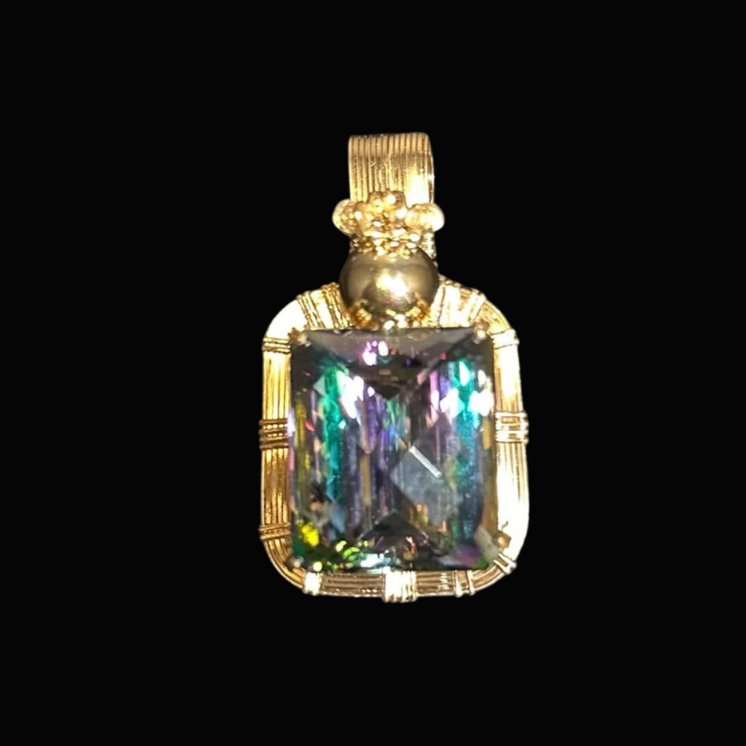 Gold pendant with a large, rectangular, multicolored gemstone set in an ornate gold frame and bail.